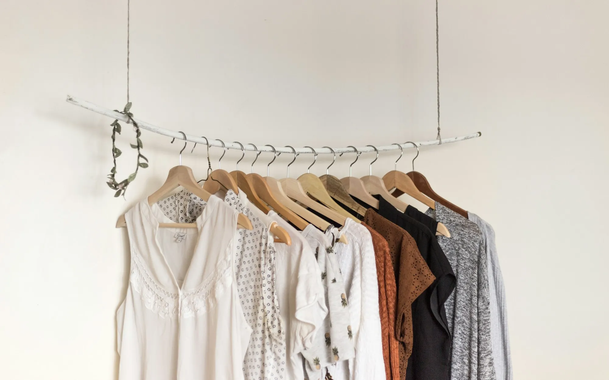 A minimal designer coat hanging in a quiet studio